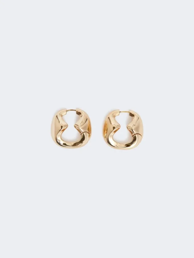 Iögonfallande metallörhängen, brons Iögonfallande metallörhängen, brons